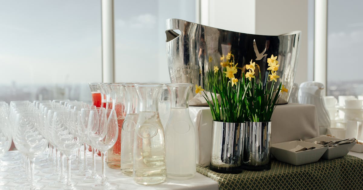 Beautiful banquet table with glassware, daffodils, and drinks ready for a festive occasion.